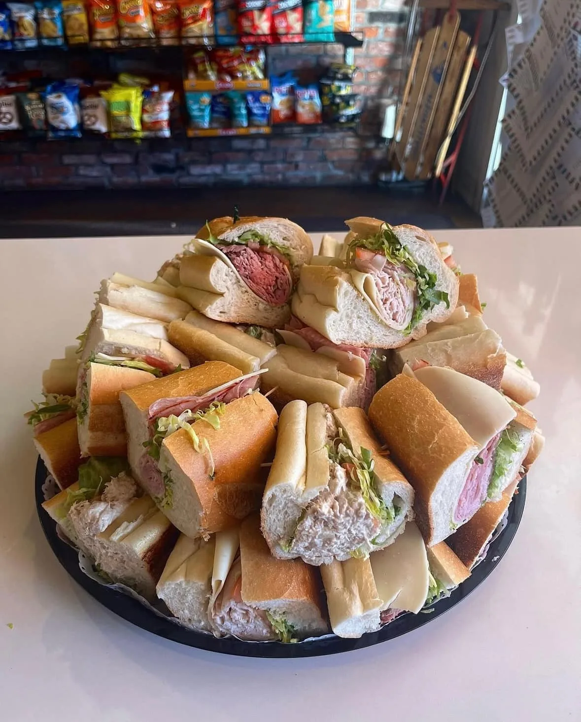 A catered platter of assorted sandwiches and wraps